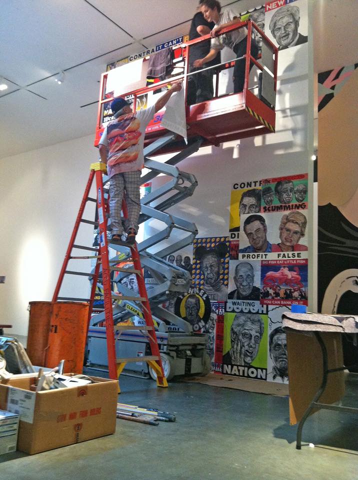 Robbie Conal installs a collage of posters