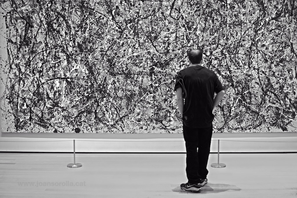 Jackson Pollock in front of his painting